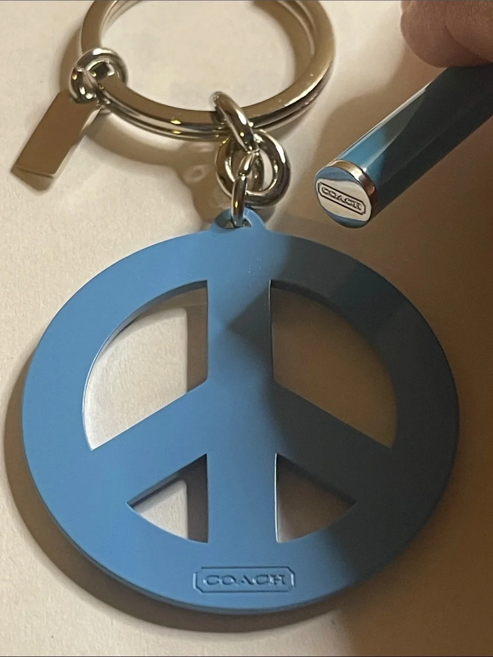 Coach Light Blue Crystal Peace Sign Keyring and Coach Pen